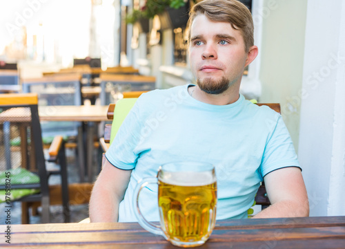 Portrait of a happy young man with beer mug