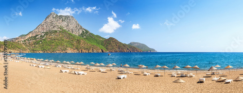 beach with umbrellas and sunbeds on the shores of the Mediterranean Sea in Turkey photo