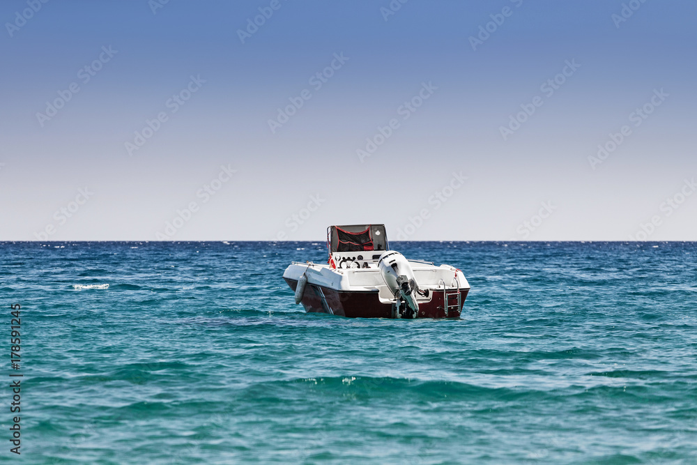 a motor boat stands in a sea bay, the concept of passenger transport in the beach resort