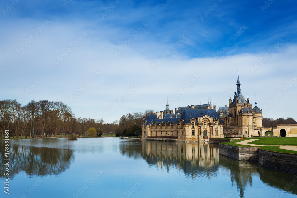 Chantilly castle reflected in water of lake Chantilly castle reflected in water of lake