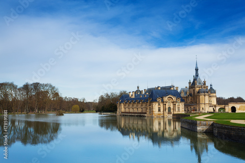 Chantilly castle reflected in water of lake
