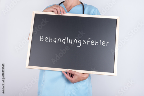 Arzt mit Schild Behandlungsfehler photo