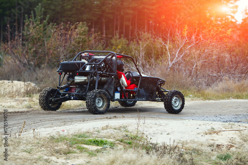 Buggy Car in the Sunlight. Driver With the Second Assistants in the Car Buggy Ride. Riding  Buggy photo