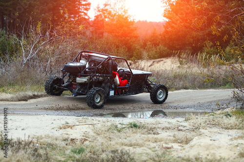 Buggy Car in the Sunlight. Driver With the Second Assistants in the Car Buggy Ride. Riding  Buggy photo