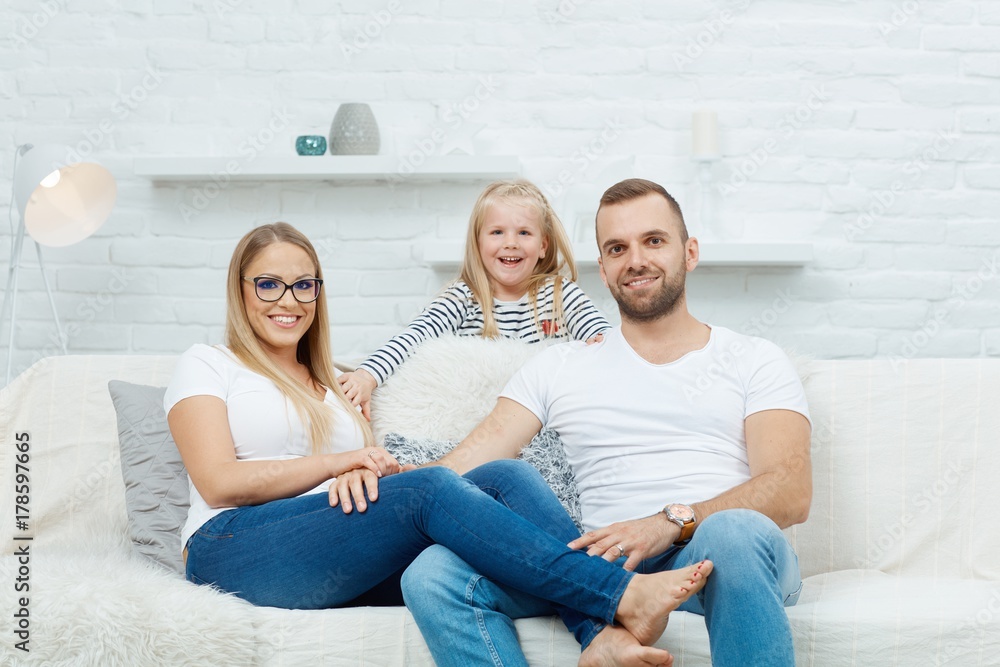 Happy family sitting on couch at home