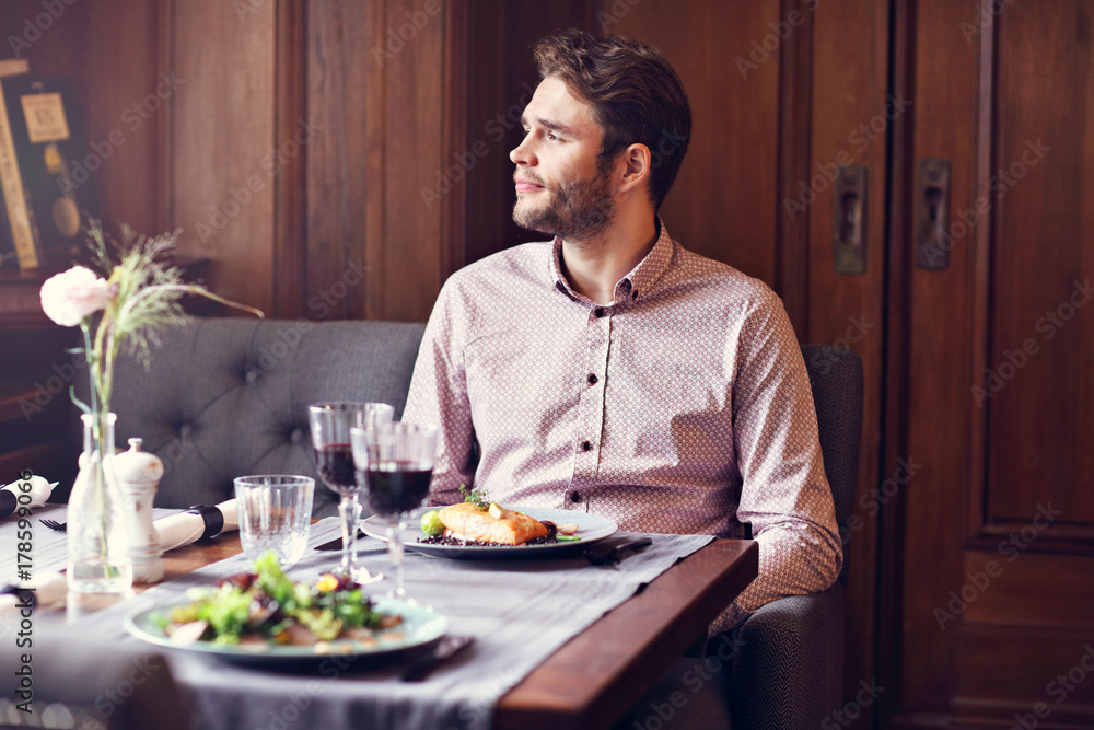 Handsome man waiting at table in restaurant Handsome man waiting at table in restaurant