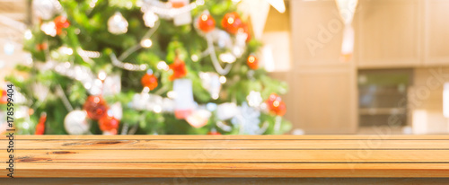 Wooden board empty table top blurred background. Perspective brown wooden table over blur christmas tree background. Panoramic banner. Can be used mock up for montage products display or design layout