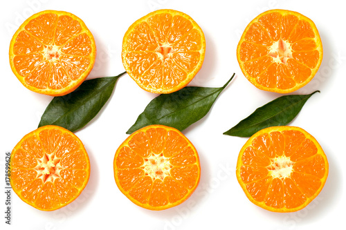 Halves of oranges with leaves on white