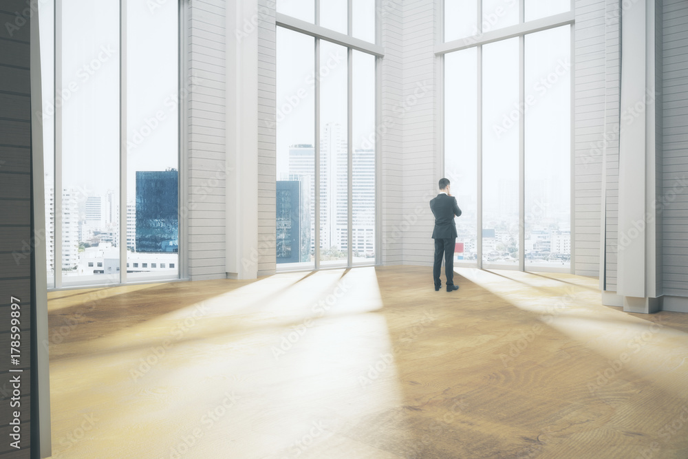 Thoughtful businessman in room Thoughtful businessman in room