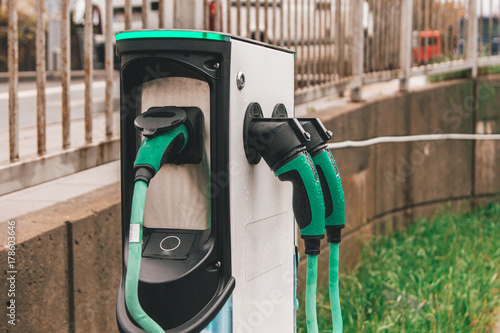 Charger for electric cars in a green color on the parking lot