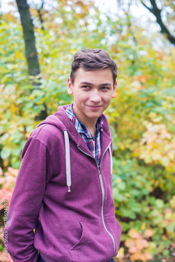 Portrait of a joyful teenage boy in an autumn forest Portrait of a joyful teenage boy in an autumn forest