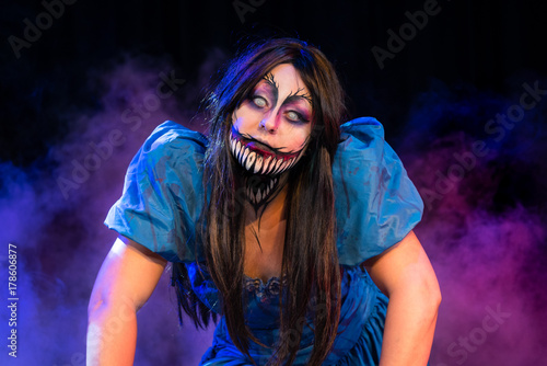 What Lies Beneath Female Model with custom special effects makeup on a stage with theatrical lighting. Halloween and horror themed