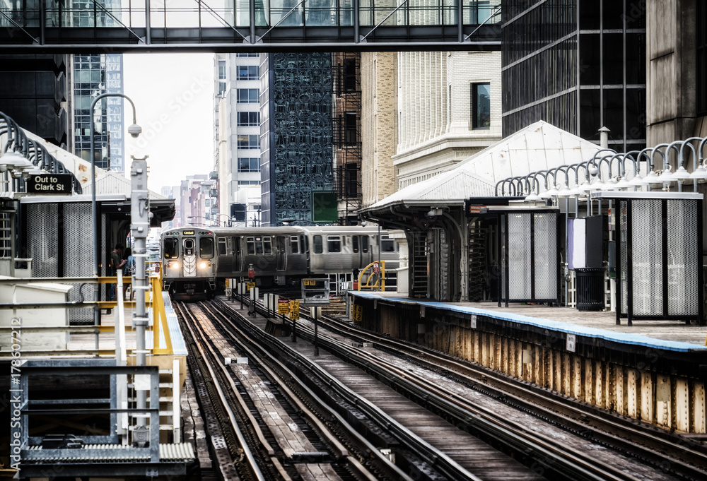 Train on elevated tracks within buildings at the Loop, Chicago City Center - Bleached Portrait Artistic Effect - Chicago, Illinois, USA