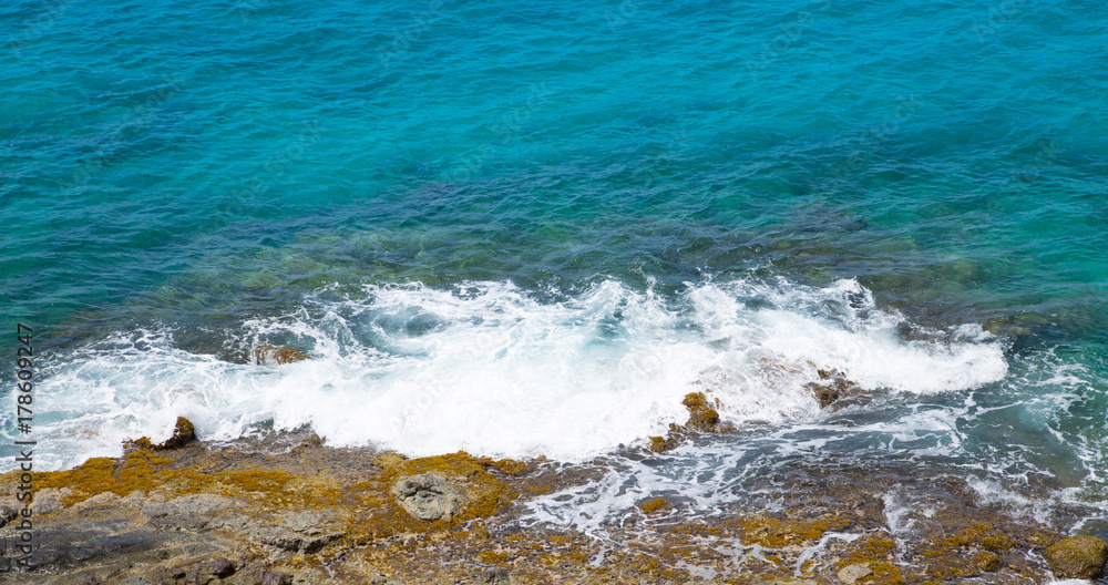 Tropical warm water of Caribbean sea with transparent sea bottom and rocks. Antigua, Caribbean island 
