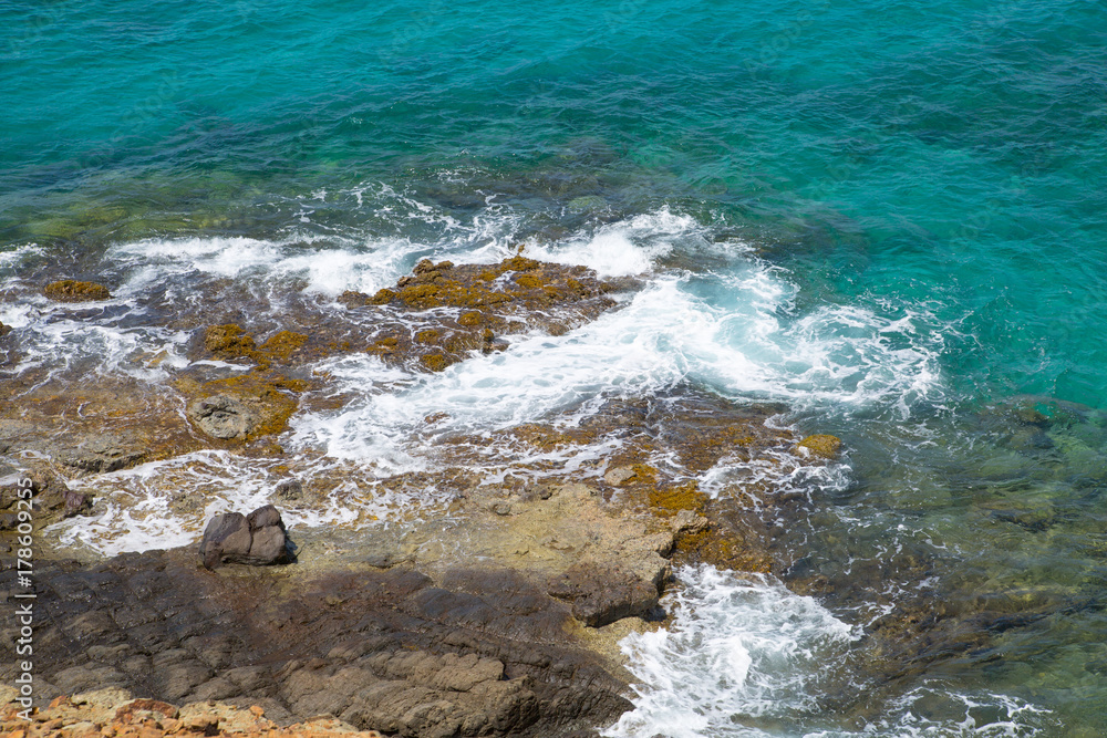 Tropical warm water of Caribbean sea with transparent sea bottom and rocks. Antigua, Caribbean island 