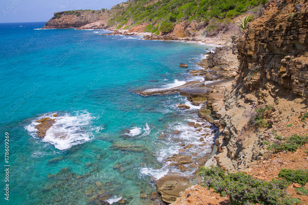 Tropical warm water of Caribbean sea with transparent sea bottom and rocks. Antigua, Caribbean island 