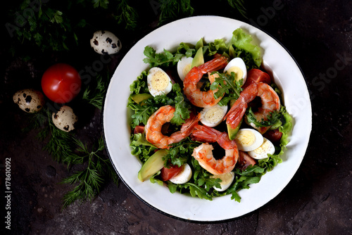 Salad from shrimp tails with lettuce, arugula, quail eggs, cherry tomatoes, avocado, olive oil and balsamic vinegar.