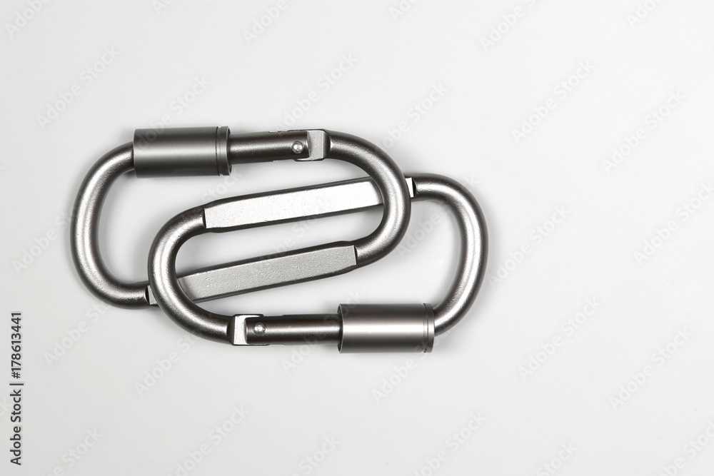 two united grey climbing carabiner on a white background two united grey climbing carabiner on a white background
