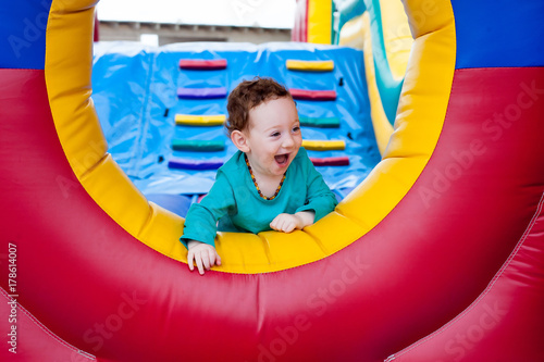 Happy toddler peeking on trampoline