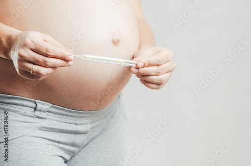 pregnant girl with a thermometer