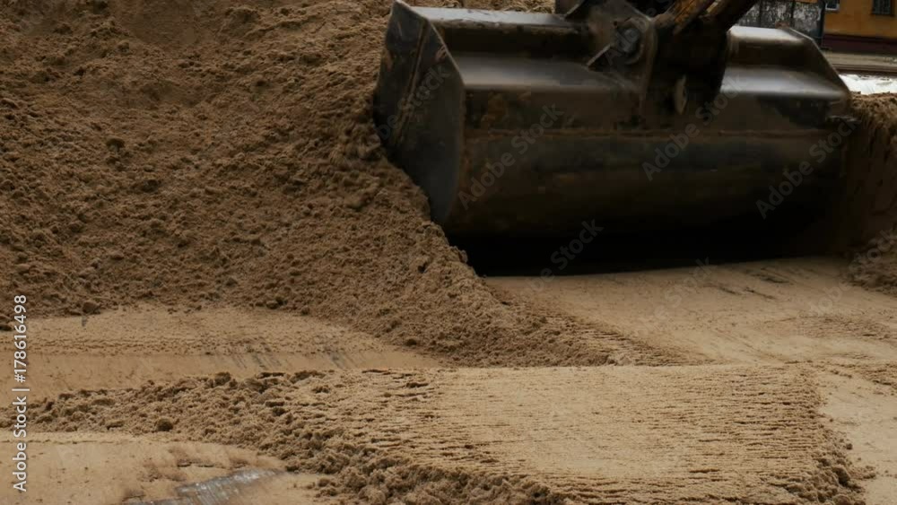 Closeup loader excavator at road construction work Closeup loader excavator at road construction work