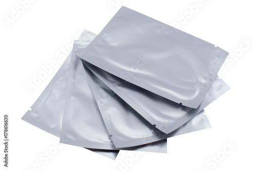 Cosmetic goods in silver, sealed packaging on a white isolated background.
