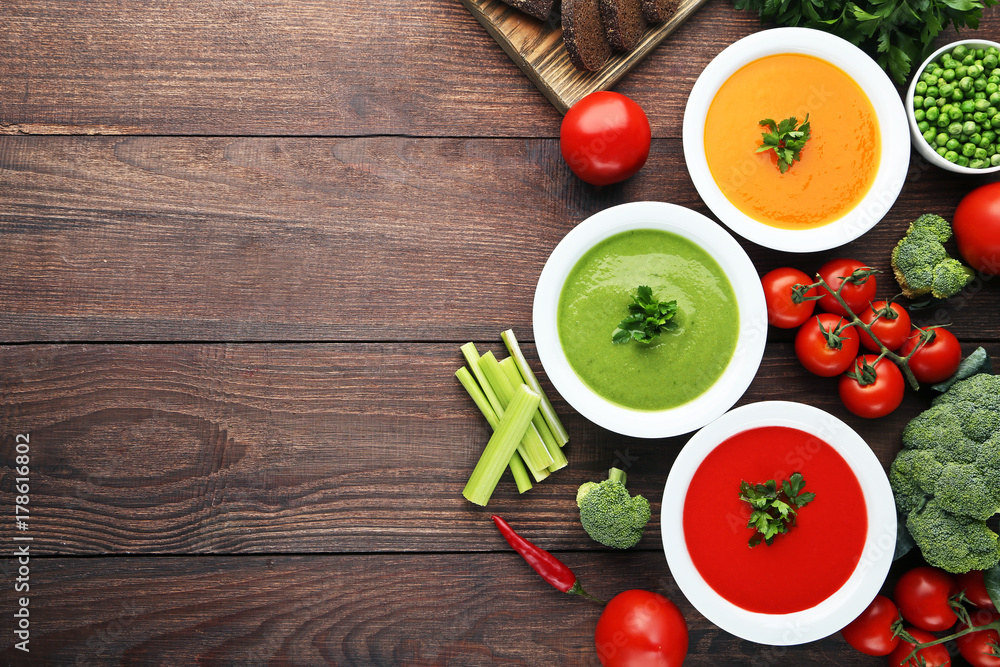 Vegetable cream soup with parsley on wooden table Vegetable cream soup with parsley on wooden table