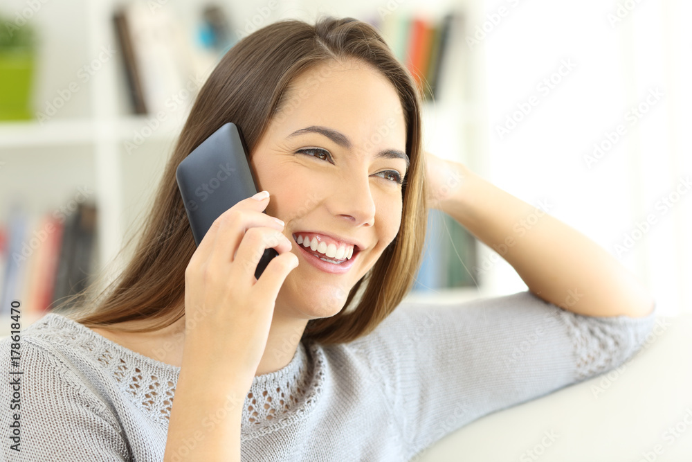 Lady talking on mobile phone seated at home Lady talking on mobile phone seated at home