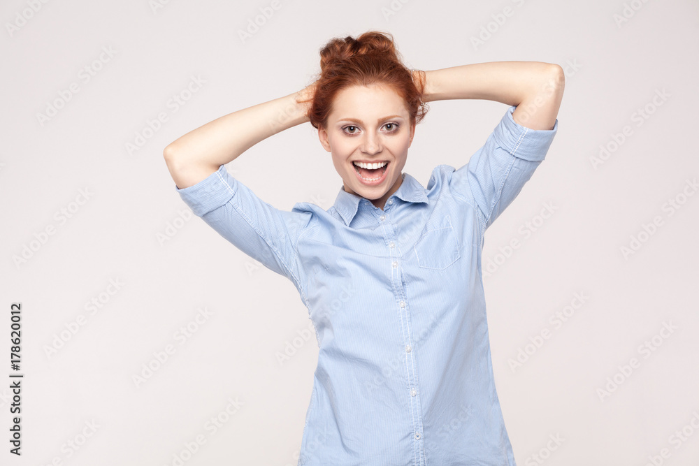 Freedom and beautiful ginger businesswoman, holding hand near head and relax and toothy smile. Freedom and beautiful ginger businesswoman, holding hand near head and relax and toothy smile.