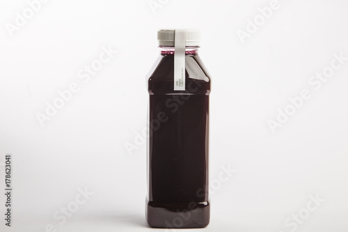 Fresh pressed organic beet juice in big size plastic bottle on the white background. Healthy drink. Detox juice diet