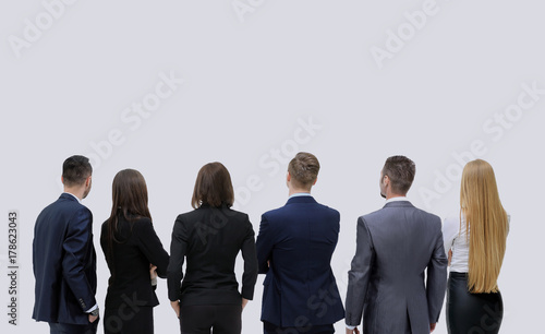 Successful business team looking upwards standing back side
