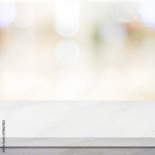 Empty white marble table over blur store background, product and food display montage