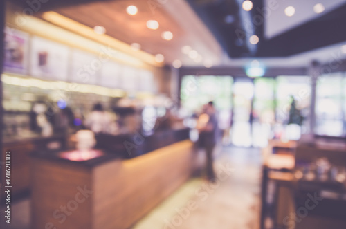 Blurred background made with Vintage Tones,Coffee shop blur background with bokeh and working man in cafe photo
