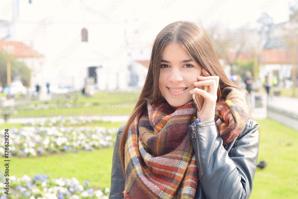 Portrait of a young woman outdoors.