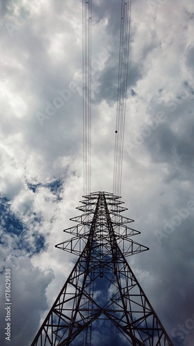 high angle view. electrical poles of high volt with electric cable. has cloud and sky are background. this image for danger, business, industry, nature, building, scenery concept