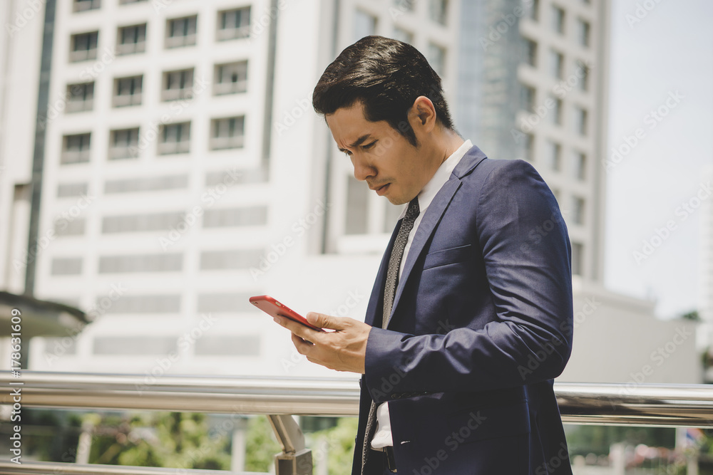 Portrait of happy businessman using telephone outdoors Portrait of happy businessman using telephone outdoors