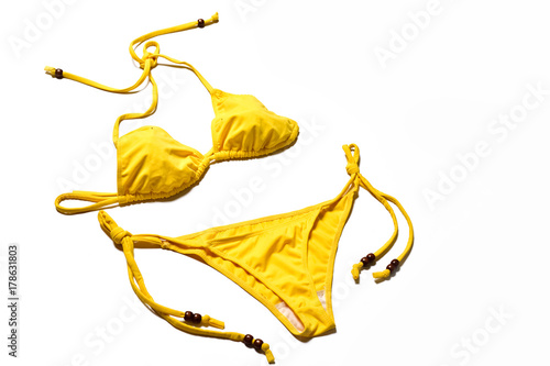 Obraz na plátně Yellow bikini on white background