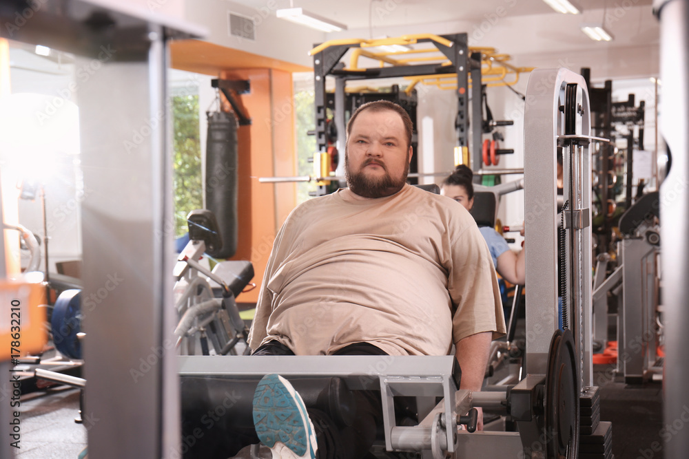 Overweight man training in gym Overweight man training in gym