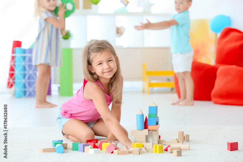 Beautiful girl playing with blocks indoor Beautiful girl playing with blocks indoor