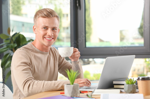 Young male student with lap...