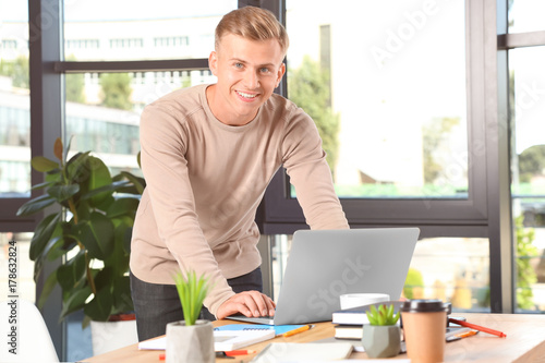 Young male student with lap...