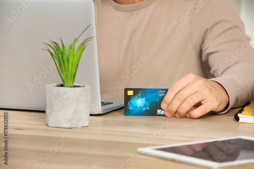 Man using credit card and l...