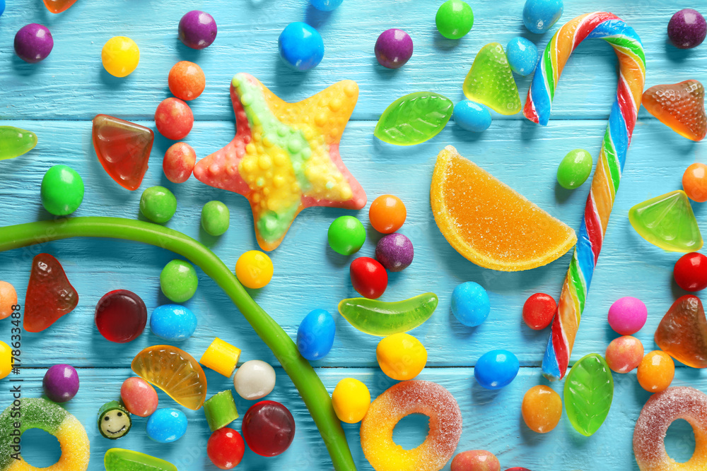 Colorful candies scattered on blue background