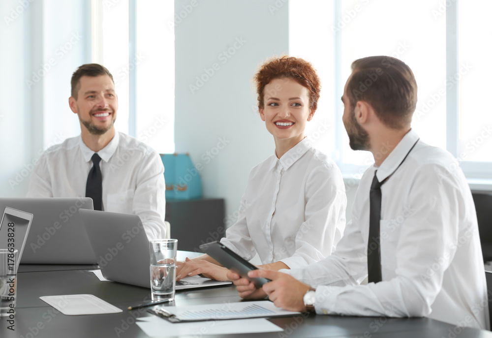 Team of young professionals conducting business meeting in office Team of young professionals conducting business meeting in office