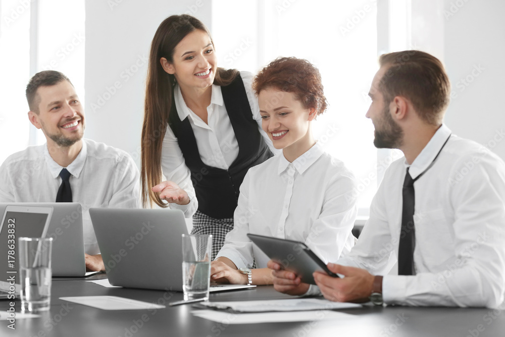Team of young professionals conducting business meeting in office Team of young professionals conducting business meeting in office