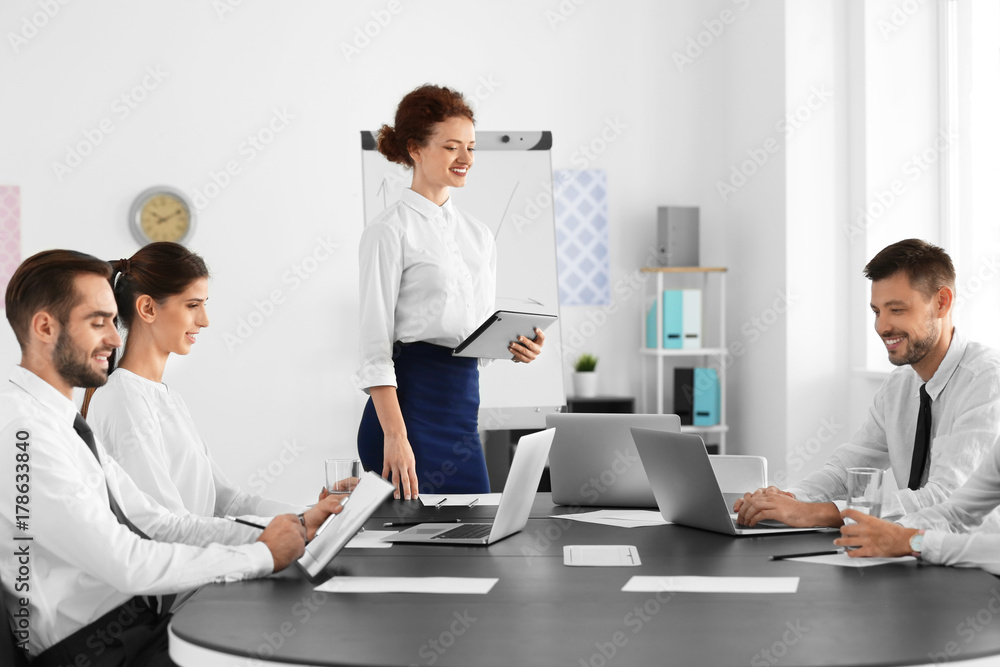 Team of young professionals conducting business meeting in office Team of young professionals conducting business meeting in office