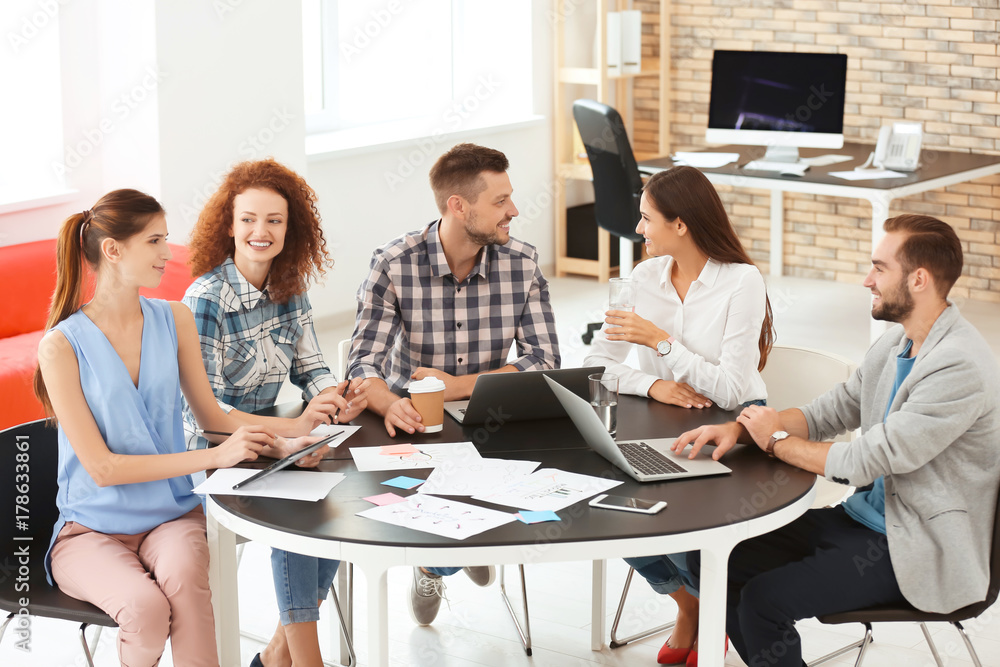 Team of young professionals conducting business meeting in office Team of young professionals conducting business meeting in office