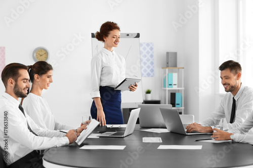 Team of young professionals conducting business meeting in office