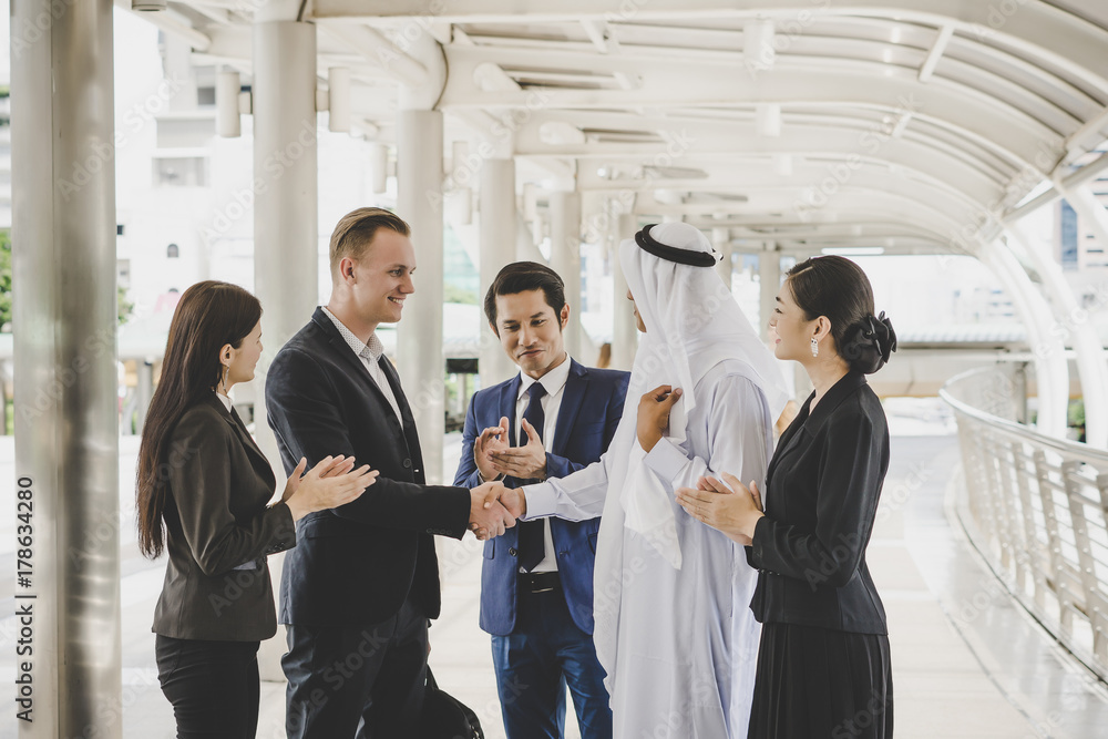 Business people shaking hands, finishing up meeting deals. Business concept. Business people shaking hands, finishing up meeting deals. Business concept.