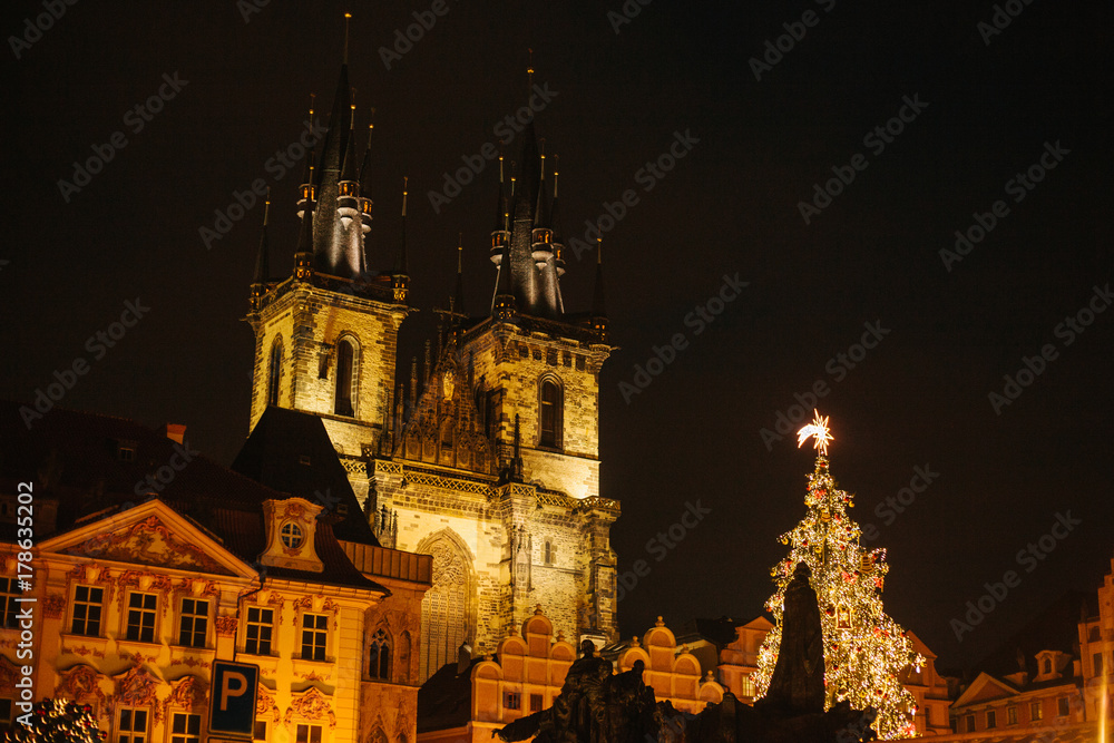 Decorated Christmas tree stands on the main square in Prague during the New Year holidays. Night view